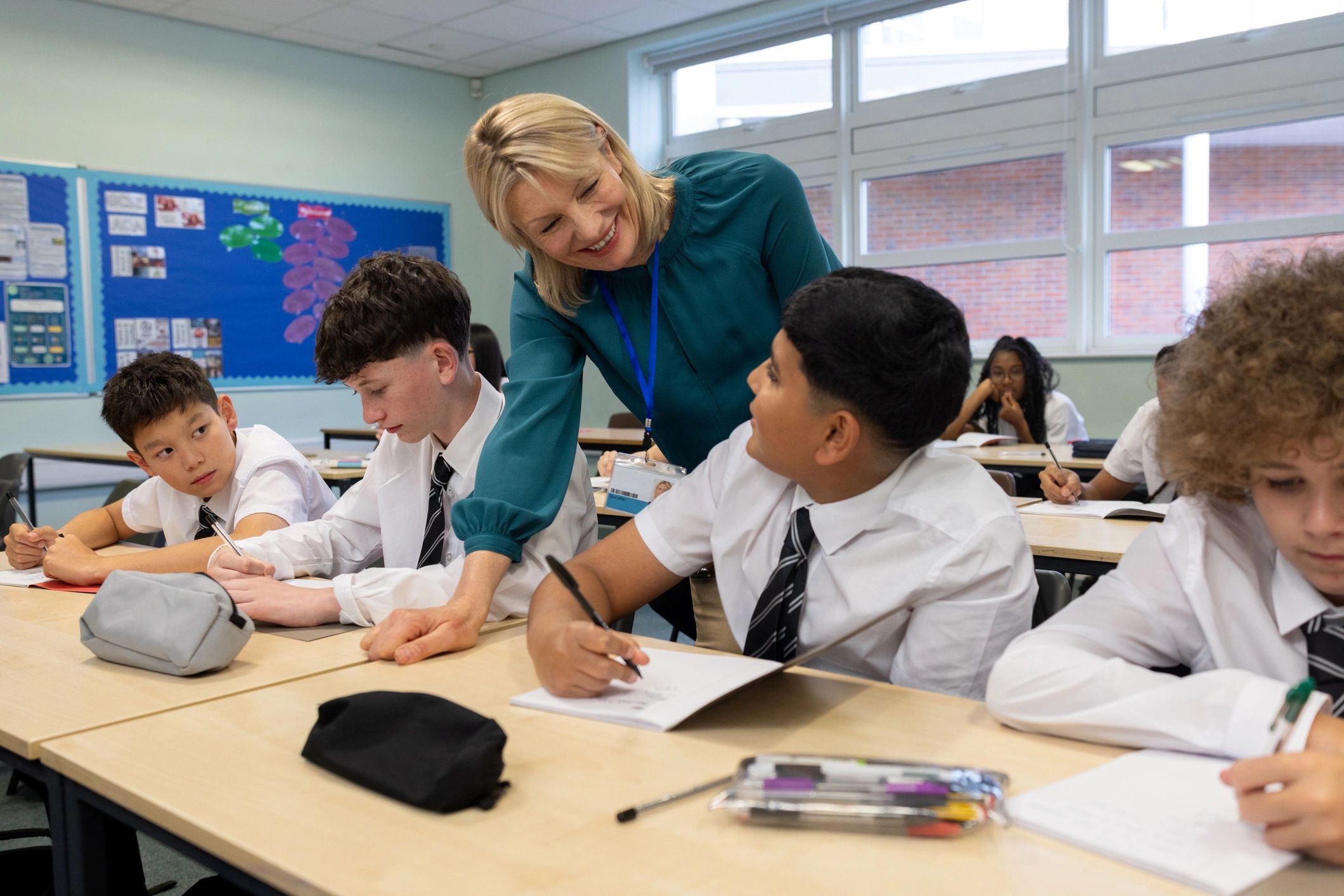 Teacher supporting students in a modern classroom